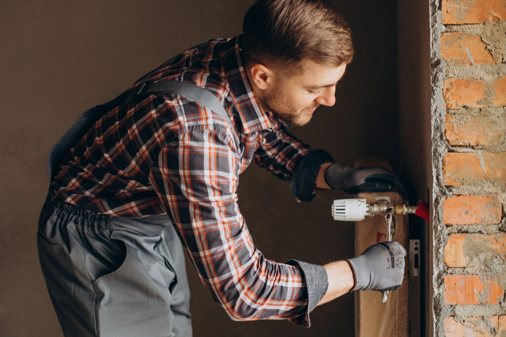 Service man adjusting house heating system